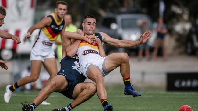 Adelaide player Myles Poholke is tackled during the South Adelaide versus Adelaide game at Noarlunga Oval. Picture: AAP Image/ Morgan Sette