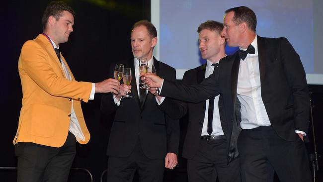 Brad Crouch is toasted by ex-Crows coach Don Pyke and last year’s winner Rory Laird.