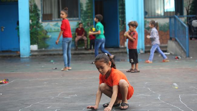 Displaced Palestinian citizens gather at the United Nations Relief and Works Agency for Palestine Refugees Beach School, after evacuating their homes damaged by Israeli air strikes. Picture: Getty Images