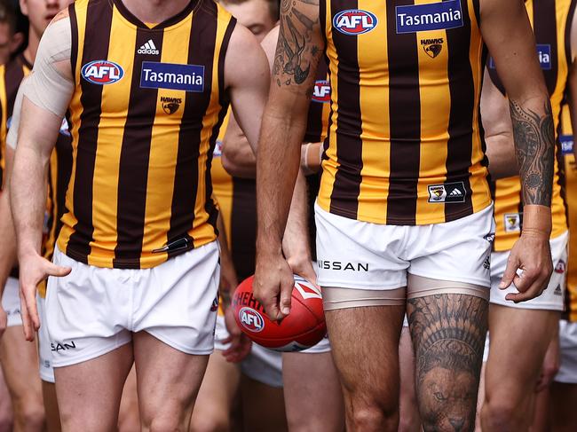 MELBOURNE, AUSTRALIA - AUGUST 21, 2021:    Shaun Burgoyne of the Hawks leads the hawks onto the ground for the round 23 AFL match between the Richmond and Hawthorn at the MCG, on August 20, 2021, in Melbourne, Australia. (Photo by Michael Klein)