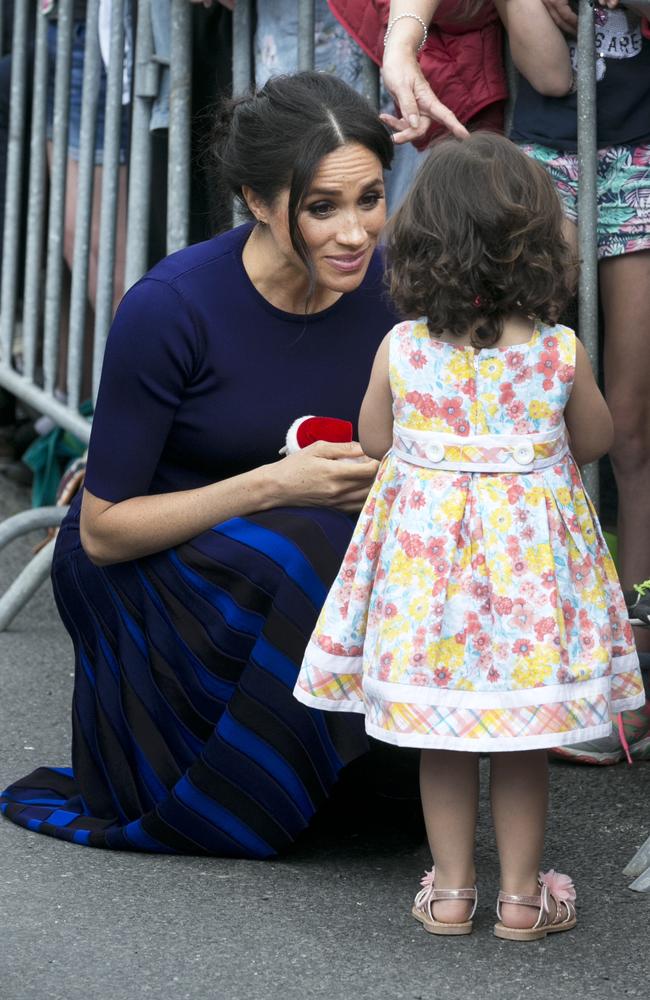 The royal tour has featured countless special moments with children. Meghan speaks to atalina Rivera, 2, who got through the railings during a walkabout in  Rotorua. Picture: Getty