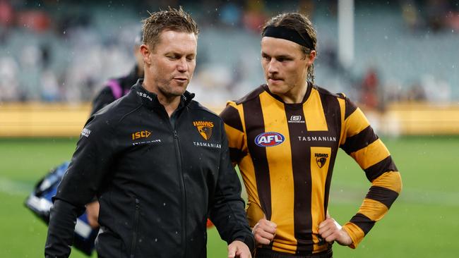 MELBOURNE, AUSTRALIA - APRIL 01: Sam Mitchell, Senior Coach of the Hawks and Jack Ginnivan of the Hawks are seen after a loss during the 2024 AFL Round 03 match between the Hawthorn Hawks and the Geelong Cats at the Melbourne Cricket Ground on April 01, 2024 in Melbourne, Australia. (Photo by Dylan Burns/AFL Photos via Getty Images)