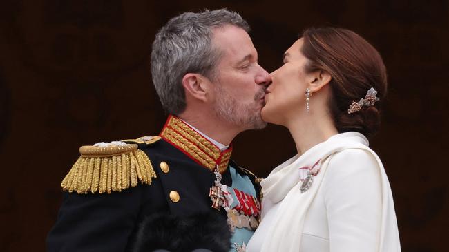 Danish King Frederik X and Queen Mary kiss on the balcony of Christiansborg Palace shortly after his proclamation on January 14, 2024 in Copenhagen, Denmark. King Frederik X is succeeding Queen Margrethe II, who has stepped down after reigning for 51 years. Picture: Sean Gallup/Getty Images