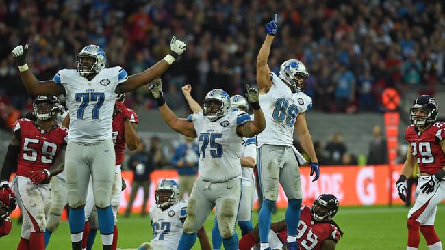 Detroit Lions players celebrate after kicker Matt Prater kicked the matchwinning field goal against Atlanta.