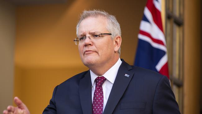 Scott Morrison says the number of people returning home from overseas will be reduced by half from Monday. Picture: Martin Ollman