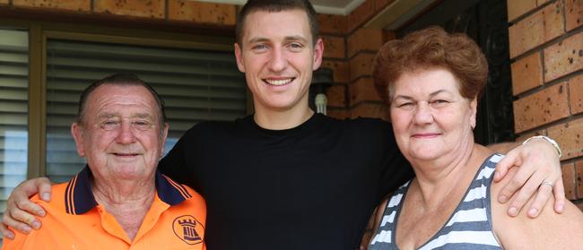 Mitchell Duke with his parents Bill and Arlene after surprising them at their Liverpool home. Picture: WS Wanderers