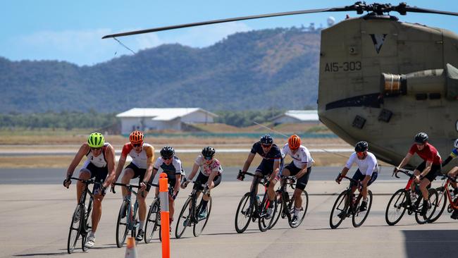 Cyclists test their speed on aircraft taxi way.