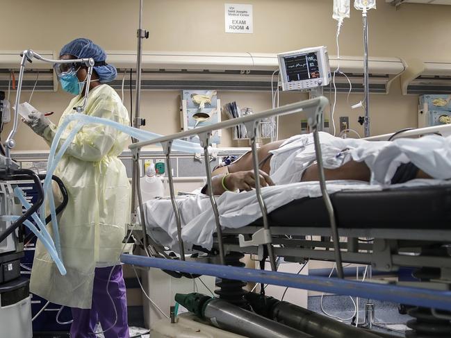 A nurse operates a ventilator for a patient with COVID-19. Picture: AP