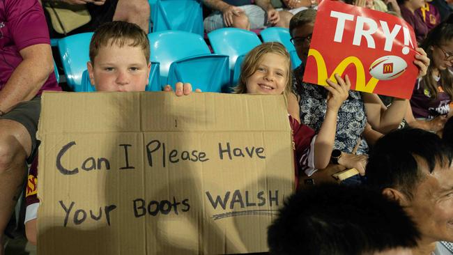 A young fan trying to get the boots of Broncos’ Reece Walsh at TIO Stadium. at the 2023 NRL match at TIO Stadium. Picture: Pema Tamang Pakhrin