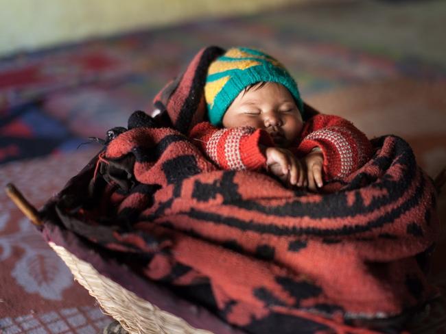 A one year old Tasha Dolkar sleeping in her traditional woven cot. Picture: Alegra Ally