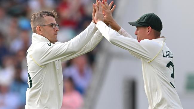 Todd Murphy celebrates the wicket of Joe Root with Marnus Labuschagne. Picture: Getty