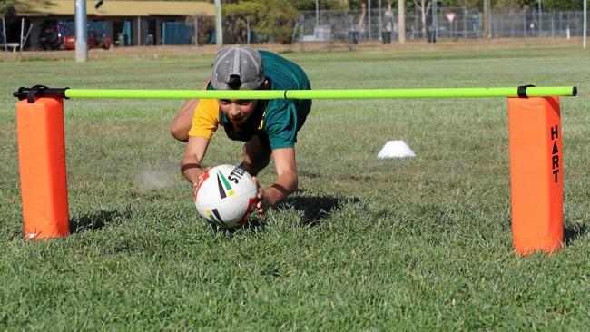 GOING UNDER: Mitch and Natalie De Rossi help Gayndah's junior touch players brush up on their skills.