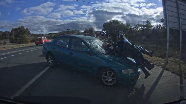 The moment Thomas Matthews' car hit three police officers. Picture: Supplied