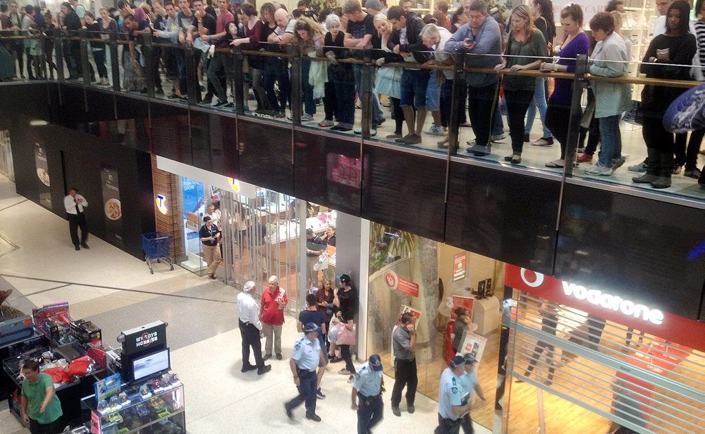 A large group of people watched on from the floor above. A bullet could be seen lying on the floor. Picture: Mikarla Marsden