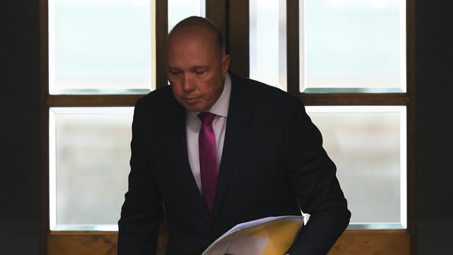 Australian Home Affairs Minister Peter Dutton leaves the chamber after introducing legislation in the House of Representatives at Parliament House in Canberra, Wednesday, September 12, 2018. (AAP Image/Lukas Coch) NO ARCHIVING