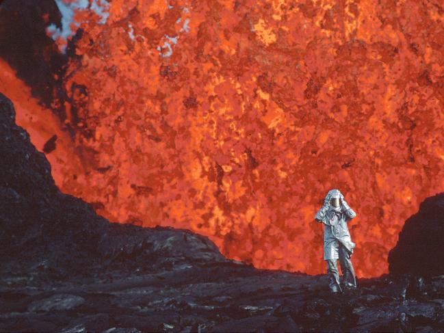Katia Krafft wearing aluminized suit standing near lava burst at Krafla Volcano, Iceland. (Credit: Image'Est). Featured in the documentary film Fire of Love directed by Sara Dosa