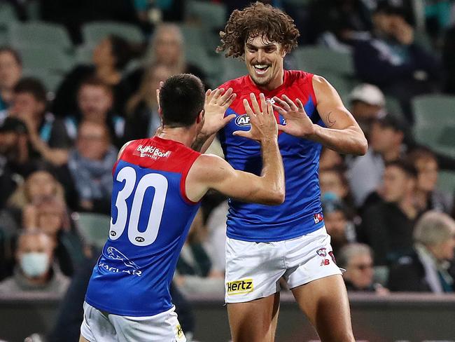 ADELAIDE, AUSTRALIA - APRIL 07: Luke Jackson of the Demons celebrates a goal with Alex Neal-Bullen as Travis Boak of the Power walks away during the 2022 AFL Round 04 match between the Port Adelaide Power and the Melbourne Demons at Adelaide Oval on April 07, 2022 In Adelaide, Australia. (Photo by Sarah Reed/AFL Photos via Getty Images)