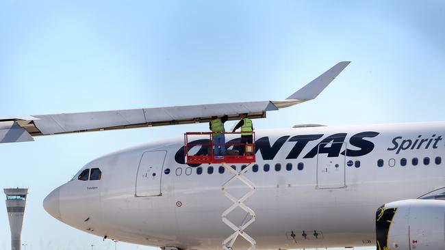 Maintenance crew working on Qantas planes at Brisbane airport. Picture: Liam Kidston.