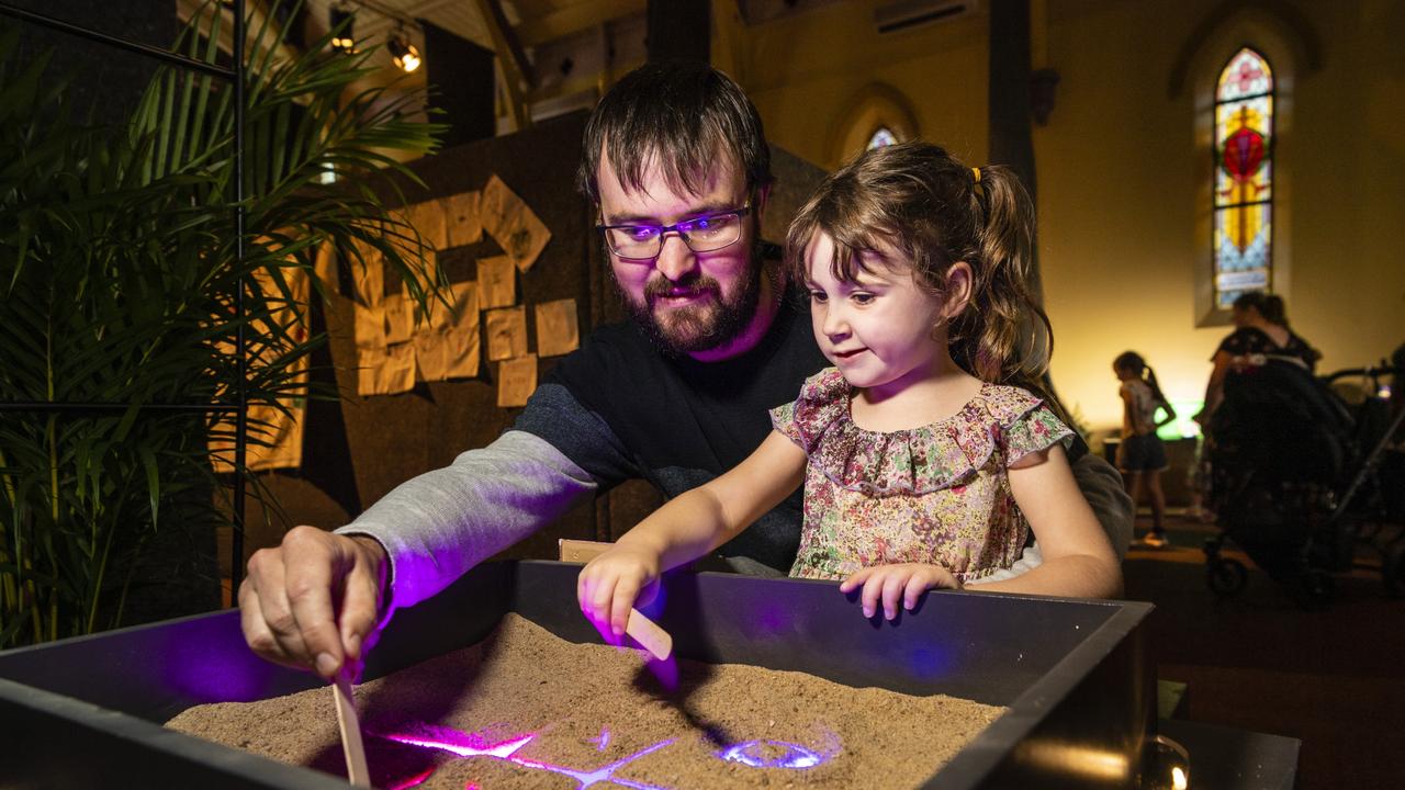 Trent and Lexi Galley play noughts and crosses in the Garden of Curiosity of the Curious Arts Festival at Empire Theatres, Saturday, April 2, 2022. Picture: Kevin Farmer