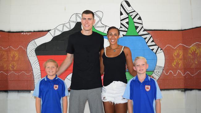 Cannonvale State School Year 4 students Summer Westley (left) and Hudson Price (right) meet Collingwood player Mason Cox and Collingwood Magpies and England Rose netballer Geva Mentor. Photo: Elyse Wurm