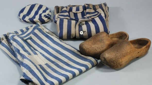 A set of prisoner clothing - trousers, blouse, hat and wooden clogs at the Auschwitz-Birkenau memorial and museum in Poland. Picture: Pawel Sawicki