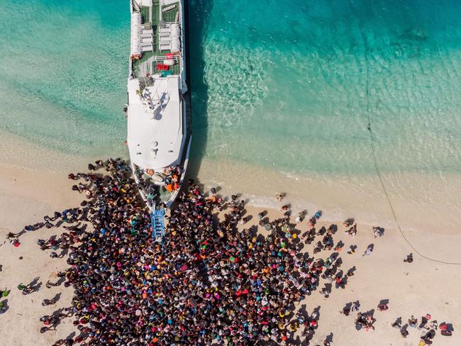 People crowding the beach as they wait to be evacuated from Gili Trawangan island. Picture: Melissa Delport/AFP