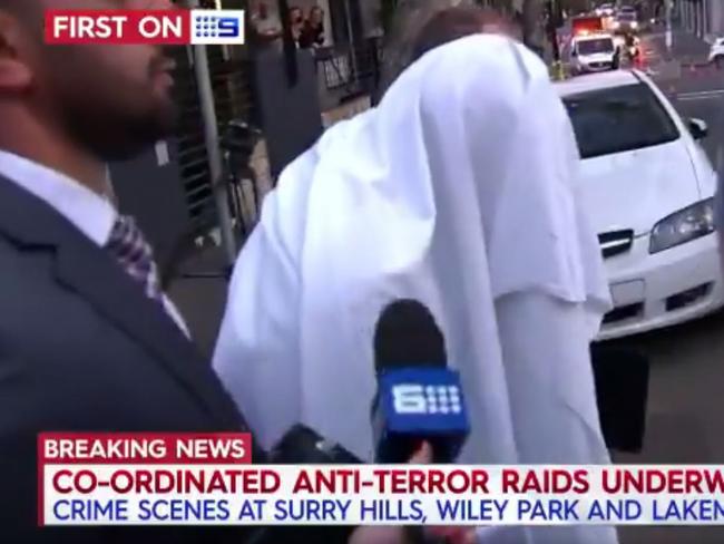 Police arrest a man during the Surry Hills raid. Picture: Nine News