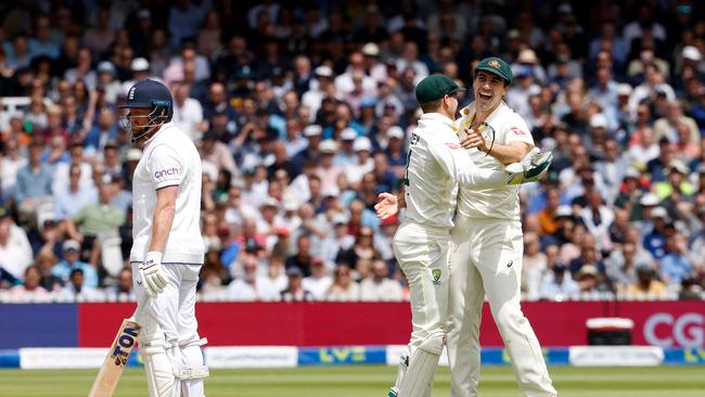 Pat Cummins (R) and wicketkeeper Alex Carey (C) celebrate Jonny Bairstow’s controversial wicket. Picture: AFP