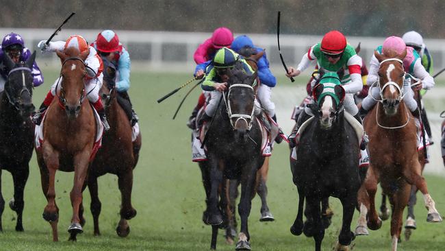 Mer De Glace ridden by Damian Lane (red cap) on his way to winning the 2019 Caulfield Cup ahead of Vow and Declare ridden by Craig Williams (orange and white quartered cap) and Mirage Dancer ridden by Ben Melham (green and blue quartered cap). Photo: Michael Klein