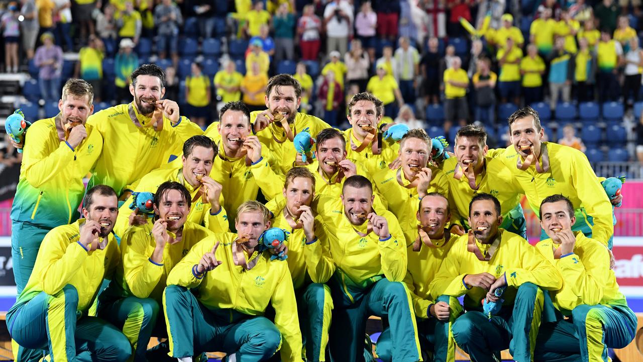 The Australian team pose for a photograph after the medal ceremony for the Men's Hockey at the 2018 Commonwealth Games. AAP Image/Dean Lewins.
