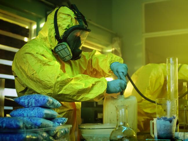 Meth lab generic 2020: In the Underground Drug Laboratory Two Clandestine Chemists Wearing Protective Masks and Coveralls Use Hosepipe For Drug Distillation. They Cook Synthesised Drugs in the Abandoned Building. iStock.