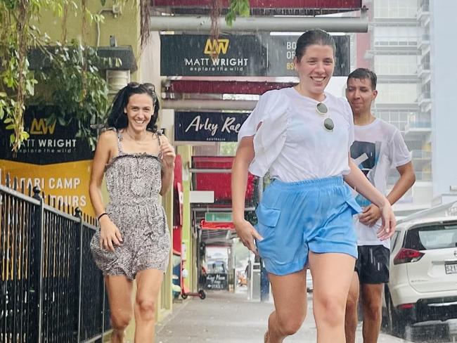 Tourists Ana Silva Adriana Maria and Francisco Rosa running from the rain Picture: Amanda Parkinson