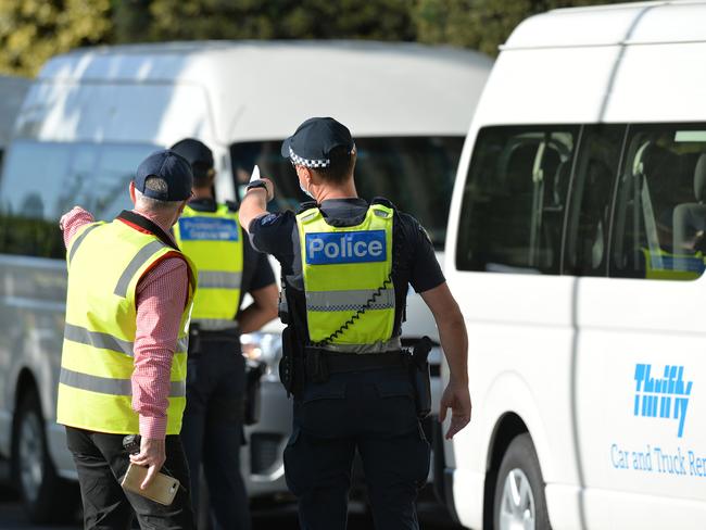 Police and officials are seen outside Albert Park’s Pullman Hotel, which is one of the hotels being used for Australian Open quarantine. Picture: Josie Hayden