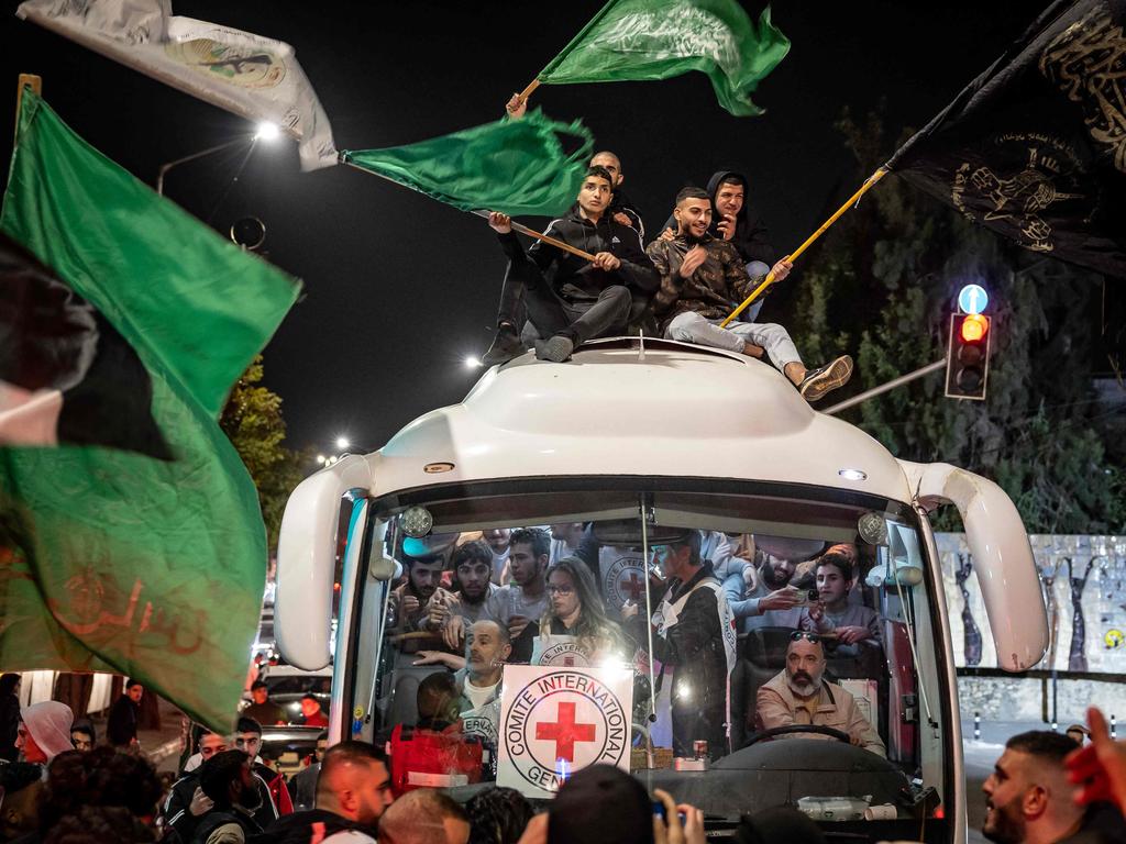 Crowds surround a Red Cross bus in the West Bank carrying 39 Palestinians released from Israeli jails. Under a temporary truce agreement, Israel is releasing prisoners in exchange for hostages released by Hamas. Picture: Fadel Senna/AFP