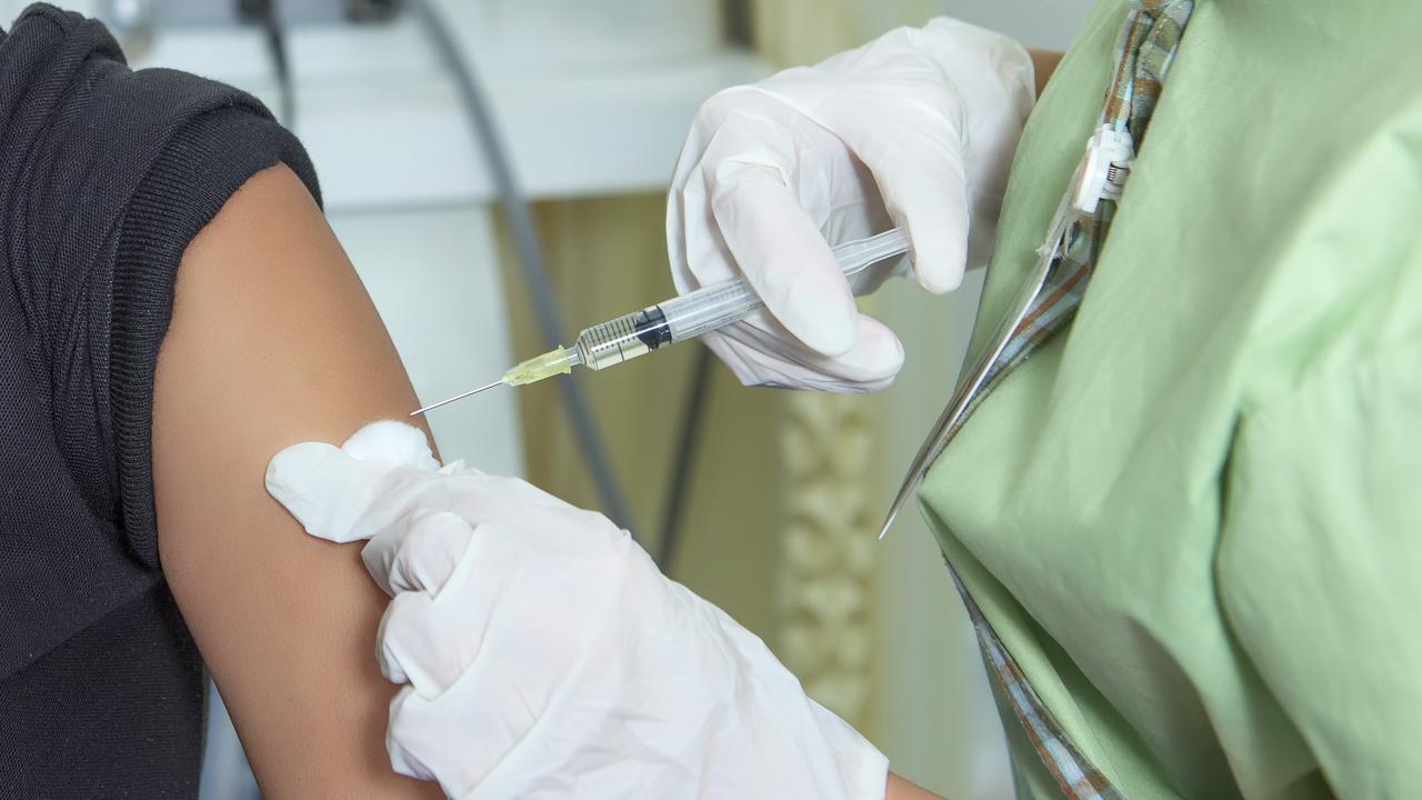 Close-up hands, nurses are vaccinations to patients using the syringe. Doctor vaccinating women in hospital. Are treated by the use of sterile injectable upper arm.