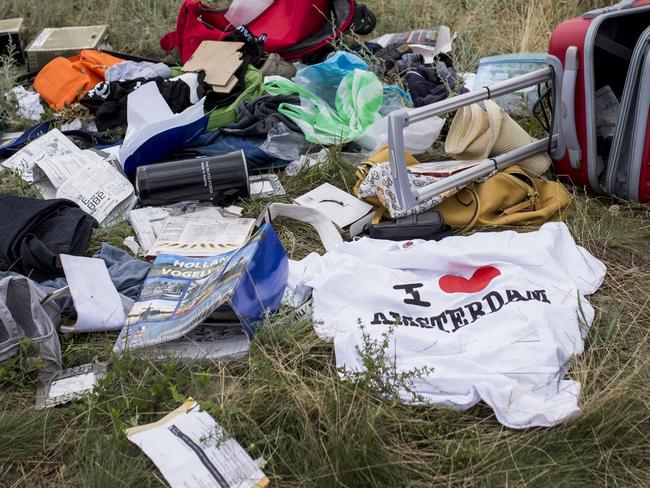 GRABOVO, UKRAINE - JULY 20: Luggage and personal belongings from Malaysia Airlines flight MH17 lie in a field on July 20, 2014 in Grabovo, Ukraine. Malaysia Airlines flight MH17 was travelling from Amsterdam to Kuala Lumpur when it crashed killing all 298 on board including 80 children. The aircraft was allegedly shot down by a missile and investigations continue over the perpetrators of the attack. (Photo by Rob Stothard/Getty Images)