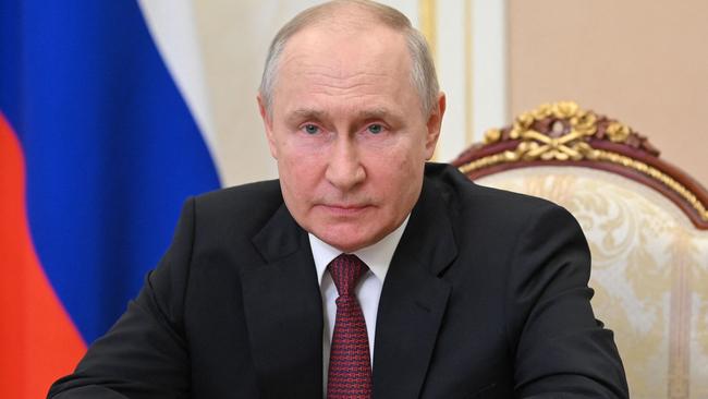 Russian President Vladimir Putin congratulates officers of investigation agencies on their professional holiday at the Kremlin in Moscow on July 25, 2023. (Photo by Alexander KAZAKOV / SPUTNIK / AFP)