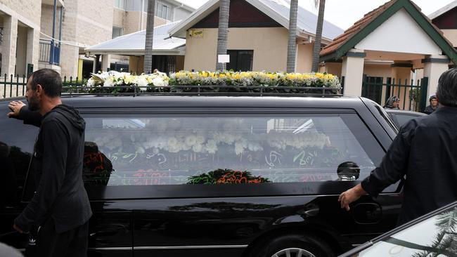 Mick Hawi’s coffin leaves in a hearse.