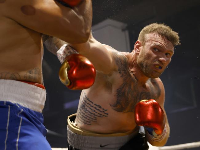 Matt Lodge lands a punch on Alex Ale at the Bella Vista Hotel. Picture: Damian Shaw