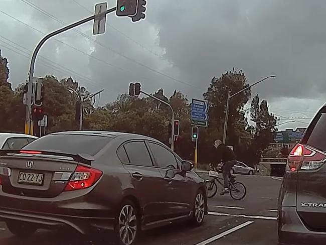 The man rode through the red crossing light. Picture: Dashcam Owners Australia