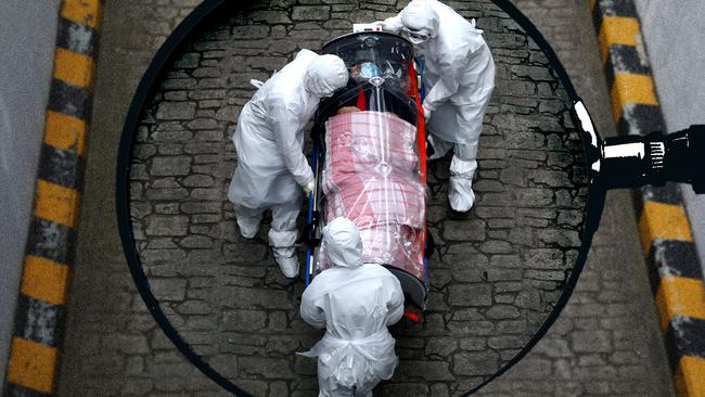 A Covid patient in China is moved by medical workers at the height of the pandemic. Artwork by Emilia Tortorella