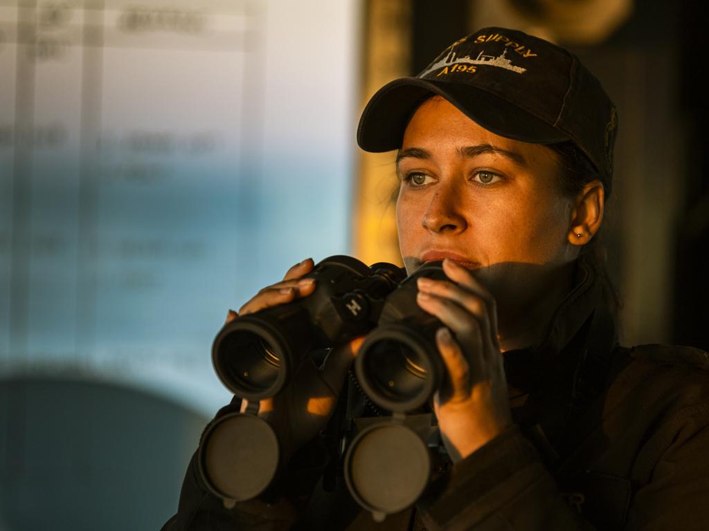 Able Seaman Boatswains Mate Roschana Harper looks out from the bridge on-board HMAS Supply, while transiting to Sydney.