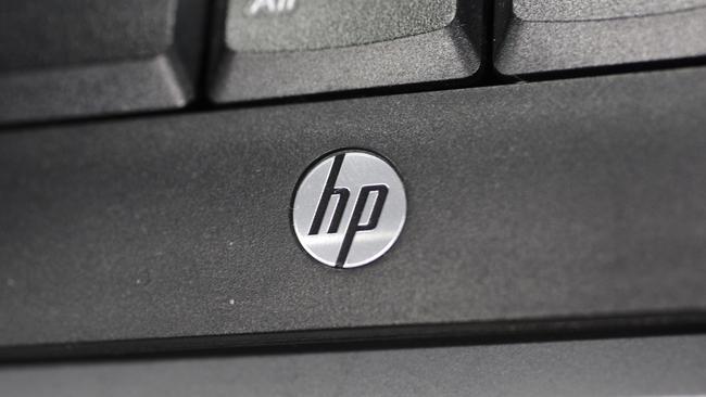 FILE - This Aug. 20, 2012, file photo shows the Hewlett-Packard logo on a keyboard at a Best Buy store in Mountain View, Calif. Hewlett-Packard reports quarterly earnings on Thursday, May 22, 2014. (AP Photo/Paul Sakuma)