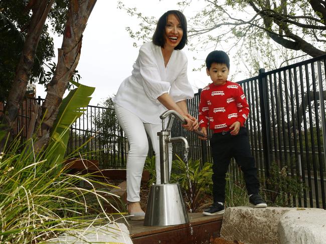 Director Mary Boyd and Sebastian Lee, 4, operate the water pump at the new playground at Woollahra Preschool. Picture: John Appleyard