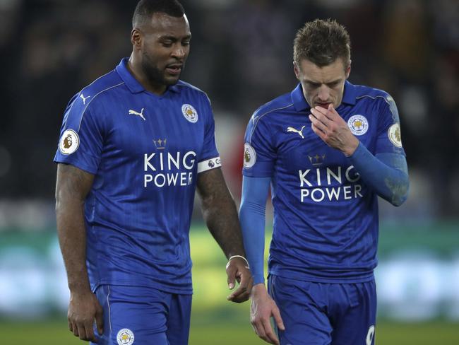 Leicester City's Wes Morgan, left, and Jamie Vardy leave the pitch after the English Premier League match Swansea against Leicester at the Liberty Stadium, Swansea, Wales, Sunday Feb. 12, 2017. (Nick Potts/PA via AP)