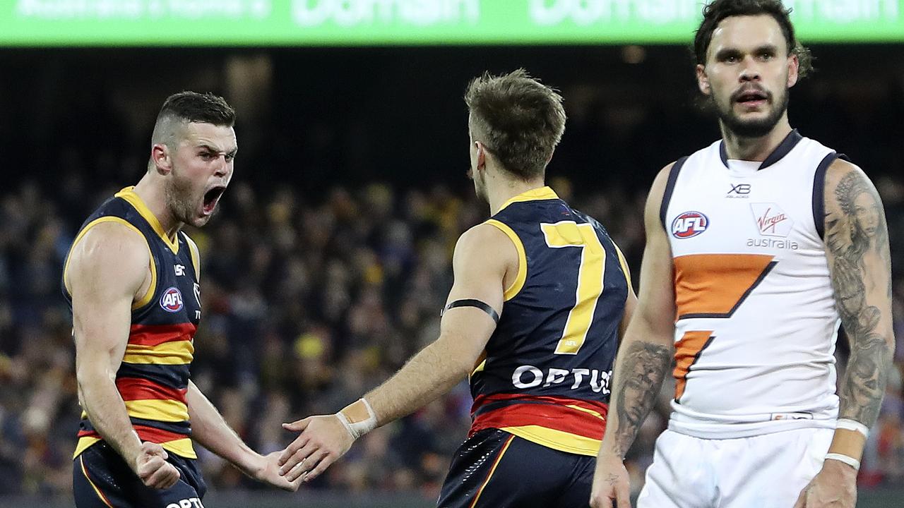 Adelaide’s Brad Crouch celebrates a goal with Jordan Gallucci as GWS defender Zac Williams shows his disappointment. Picture: Sarah Reed