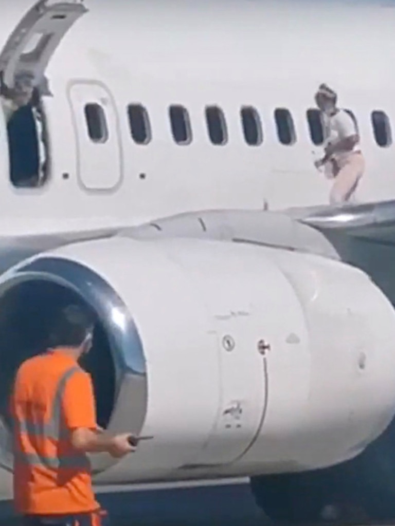 Passenger opens plane door to walk on wing because cabin was ‘too hot ...