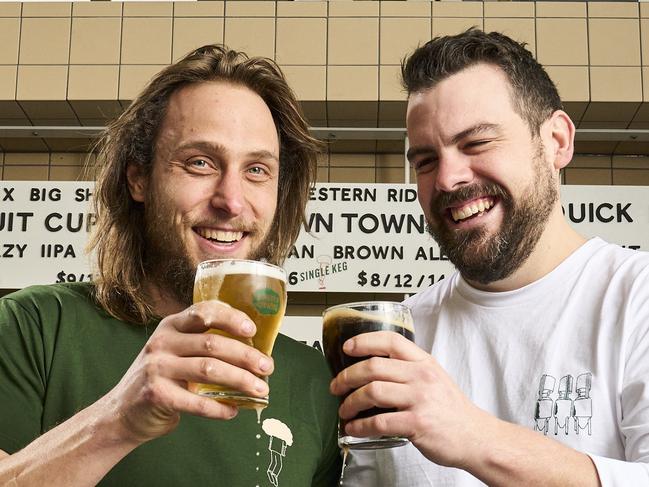 Alex Marschall and Jake Phoenix serving up beers at the new Bowden Brewing at Plant 3 that opens today in Bowden, Monday, July 5, 2021. Picture: MATT LOXTON