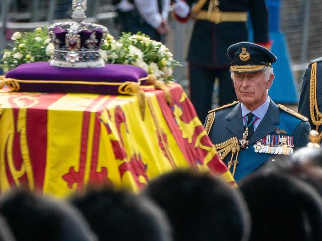 LONDON, ENGLAND - SEPTEMBER 14: King Charles III (centre) and Prince William, Prince of Wales (right) follow the coffin of Queen Elizabeth II, draped in the Royal Standard with the Imperial State Crown placed on top, carried on a horse-drawn gun carriage of the King's Troop Royal Horse Artillery, during the ceremonial procession from Buckingham Palace to Westminster Hall, on September 14, 2022 in London, United Kingdom. Queen Elizabeth II's coffin is taken in procession on a Gun Carriage of The King's Troop Royal Horse Artillery from Buckingham Palace to Westminster Hall where she will lay in state until the early morning of her funeral. Queen Elizabeth II died at Balmoral Castle in Scotland on September 8, 2022, and is succeeded by her eldest son, King Charles III. (Photo by Aaron Chown - WPA Pool/Getty Images)