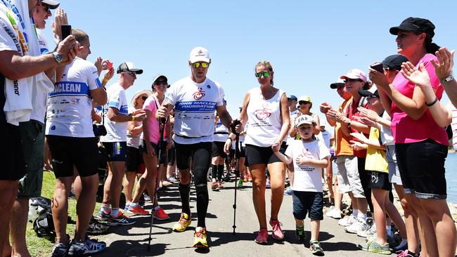 John Maclean competing in the Nepean Triathlon walks with his son Jack and wife Amanda. (Brett Costello)